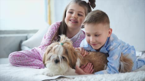 children and dog in pajamas