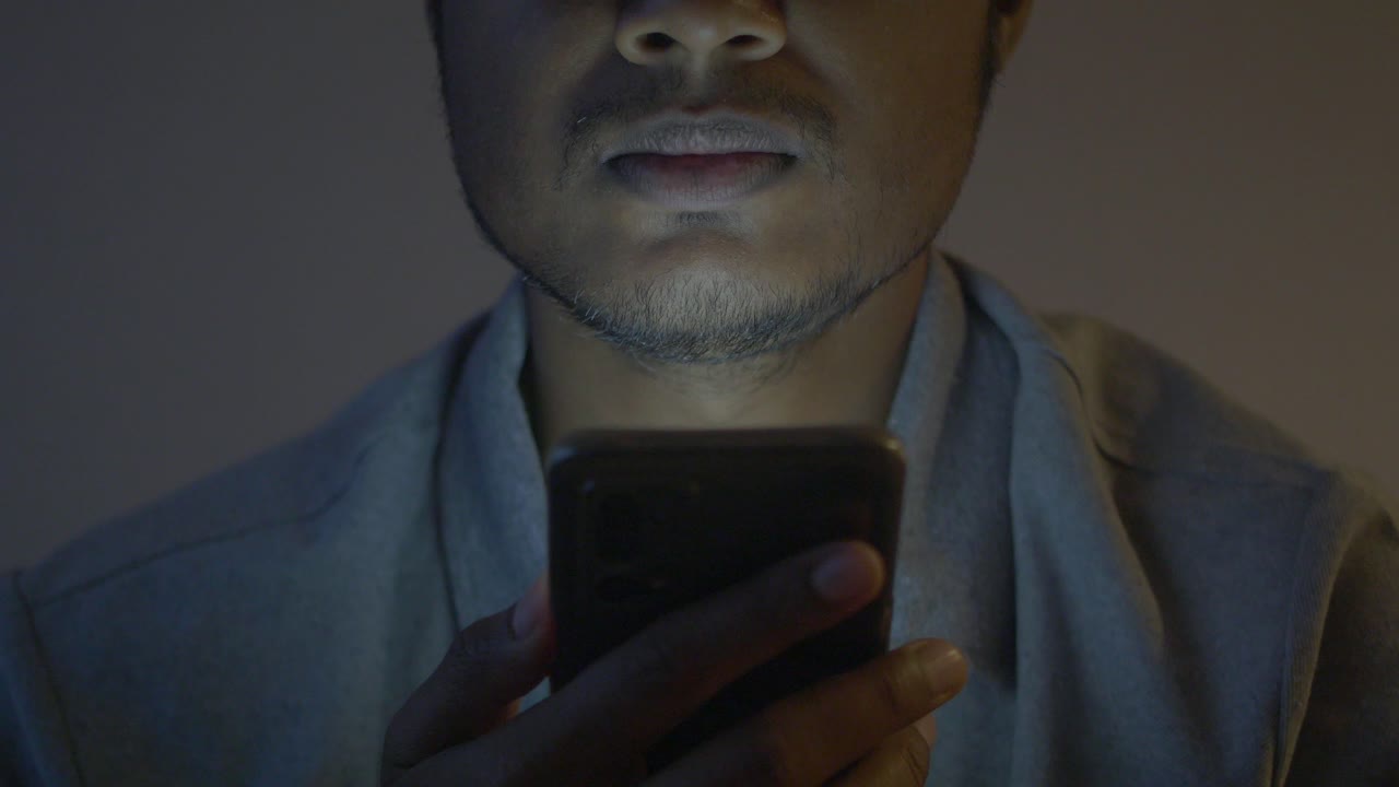 un hombre mirando su teléfono inteligente