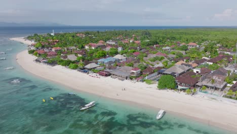 tropical tourist destination with white sand beach and resorts on shore, pantai pasir putih, aerial