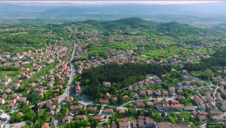 Beautiful-green-city-Sinj,-Croatia,-drone-sideways,-town-panorama-on-summer-day