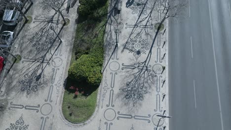 aerial top down cinematic view of portuguese sidewalk or cobblestones along of liberty avenue in lisbon