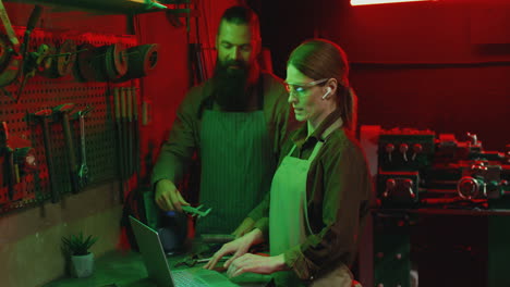 caucasian woman and man welders in workshop