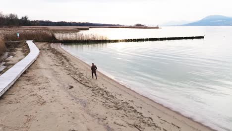 man running alone on the beach drone