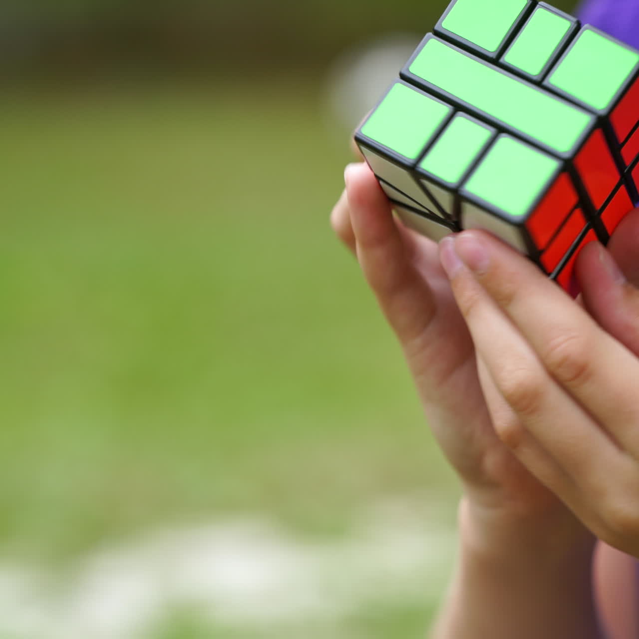 Close-up video of solving Rubik's cube. Hands of a boy shows quick combination of Rubik's cube solving puzzle to the end. Problem solving game.