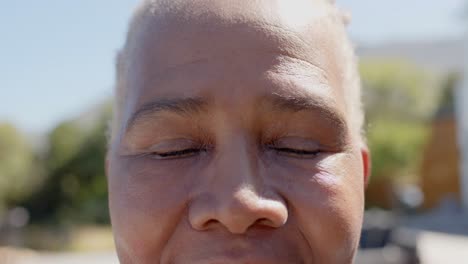 Portrait-close-up-of-happy-senior-african-american-woman-in-garden,-unaltered,-in-slow-motion