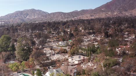 aerial low descending shot of destroyed homes within the altadena wildfire burn scar in southern california. 4k