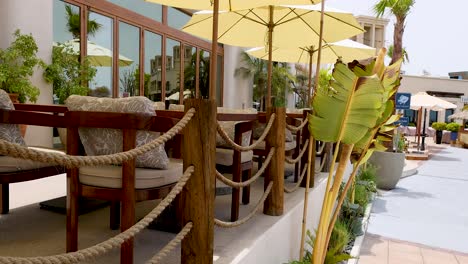 outdoor seating area with yellow umbrellas and plants