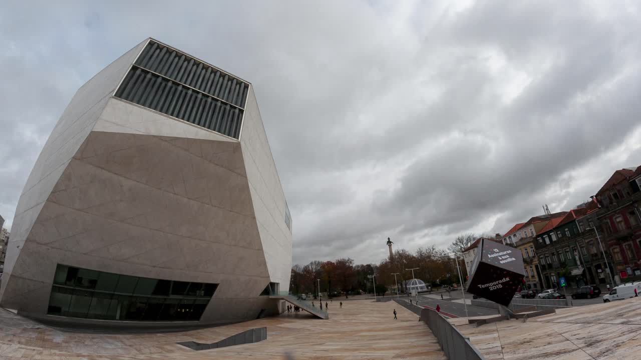 A mesmerizing timelapse of Casa da Música in Porto, Portugal, showcasing its modern architecture with clouds dynamically drifting in the background.