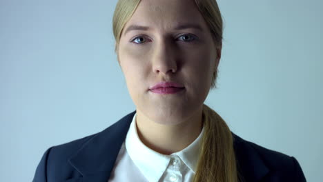 portrait beautiful young blonde business woman looking serious at camera,static