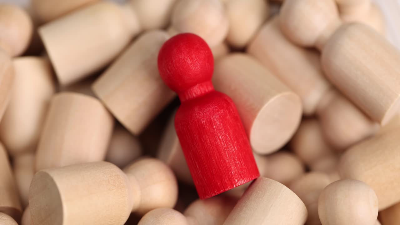 Figurines symbolizing humans lie with red figure in center