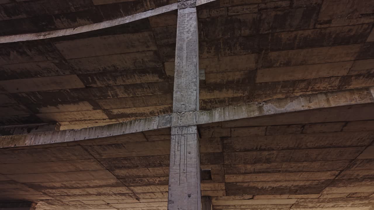 Urban construction site with exposed concrete structure and beams