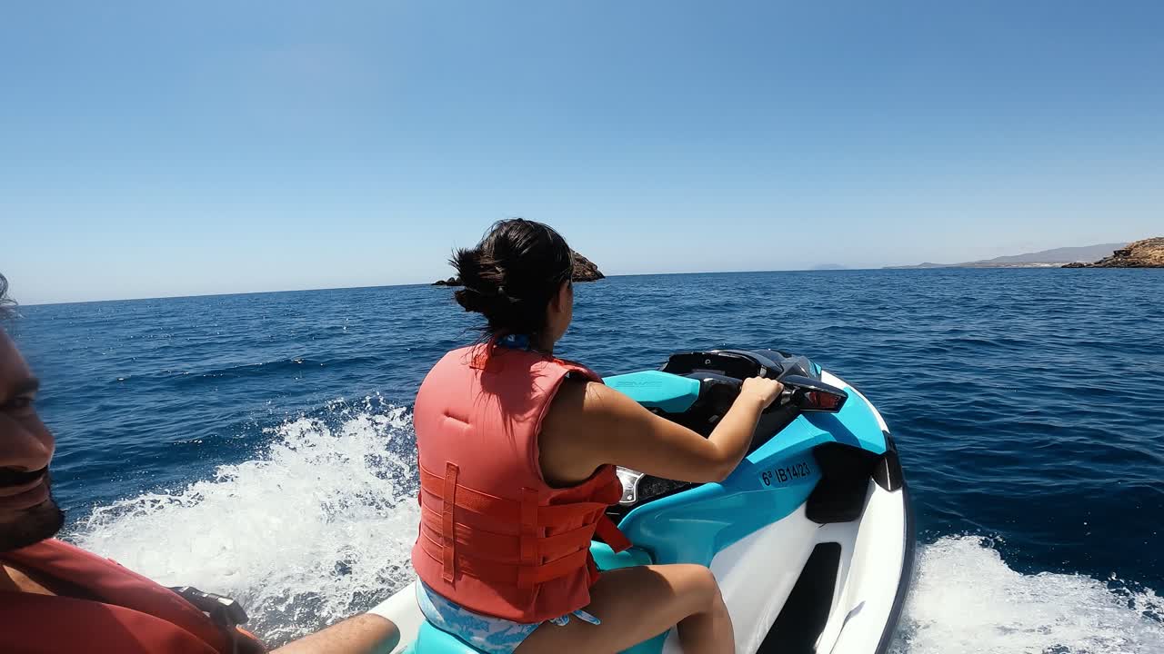 People riding a jet ski on the ocean