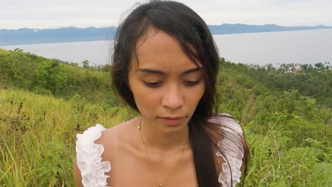 person walking in golden grass fields at the hilltop