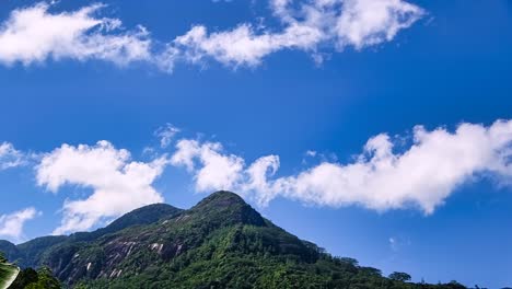 Time-lapse-of-Sunny-day,-granite-rock-mountain-and-passing-clouds,-clear-but-sky