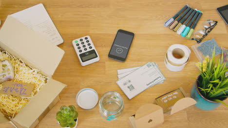 Overhead-Shot-Of-Contactless-Card-Payment-Machine-And-Debit-Card-On-Table