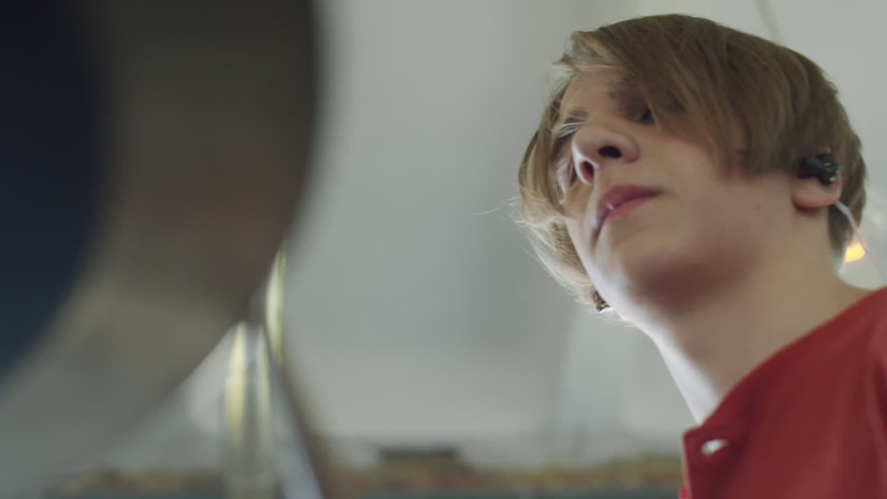 Blurred view of a drummer playing a cymbal