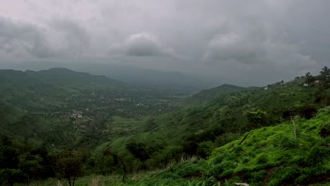 timelapse of dramatic monsoon clouds rolling over lush green mountains and dense trees in panchgani, maharashtra, capturing nature’s raw beauty as the sky shifts and mist dances through the hills