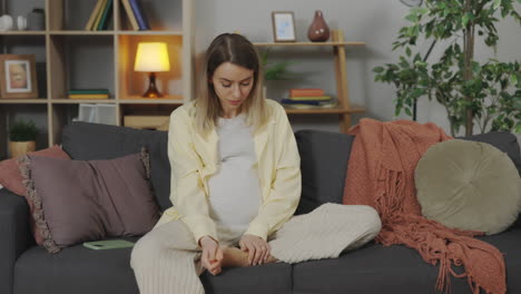 pregnant woman relaxing on a couch
