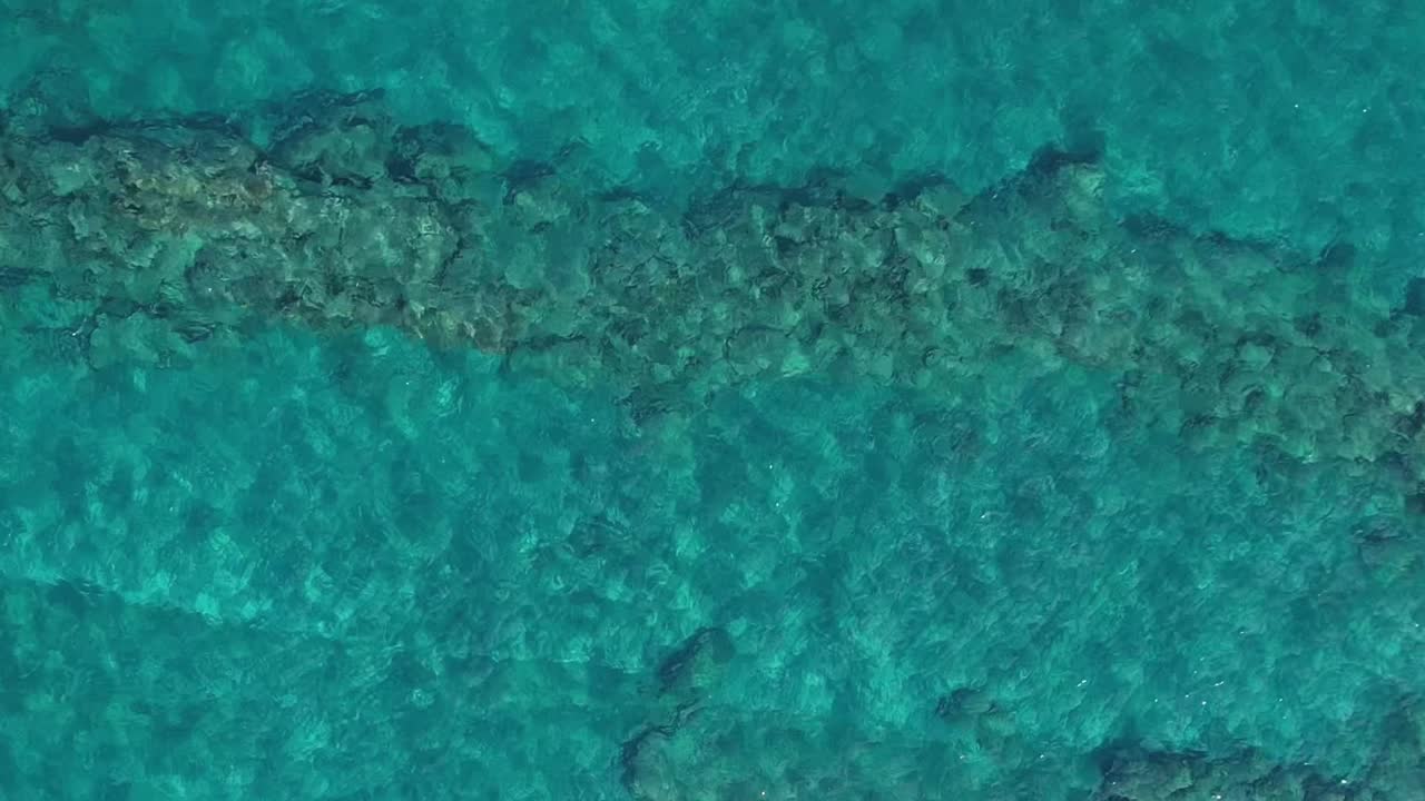 Bright turquoise waters and rocky seabed above Aegean Sea in Greece