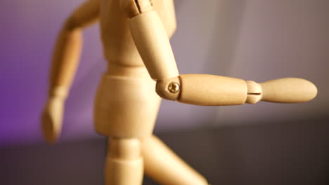 Rotating-close-up-of-a-small-wooden-mannequin-used-for-drawing-and-animation