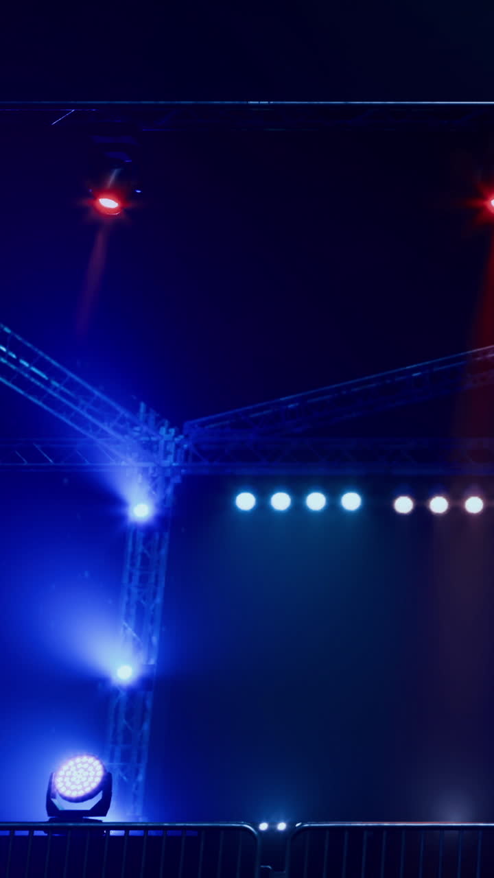 Crews work on the lighting setup for a performance at night