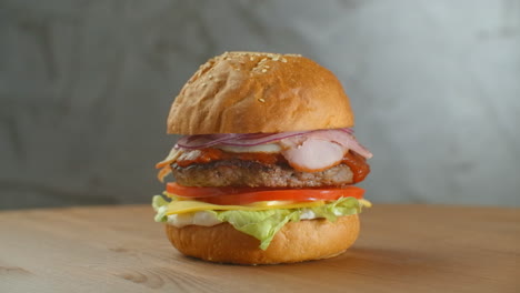 a delicious cheeseburger served on a wooden platter.