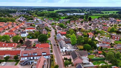 footage over the road crossing the cozy town of vierlingsbeek, netherlands. beautiful green meadows and woods at backdrop