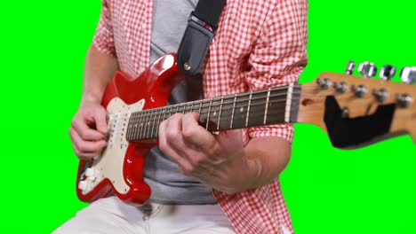 mid section of male musician playing guitar