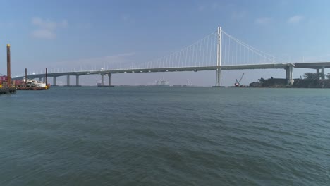 Aerial-shot-of-vehicles-moving-on-San-Francisco–Oakland-Bay-Bridge-with-city-in-background