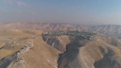 jewish settlement at the desert of judea and samaria in israel . aerial view drone shot of village houses on top hill mountains view. outdoor mediterranean coexist living