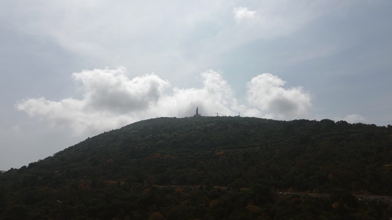 A scenic hill view in Tay Ninh, Vietnam with sunlight filtering through clouds