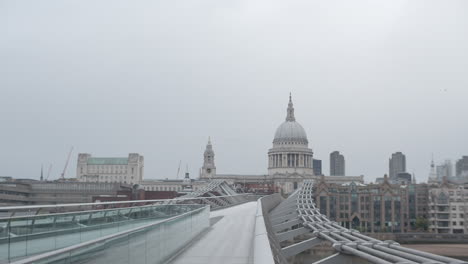 London-Millennium-Bridge-with-view-of-St-Paul's-Cathedral-at-early-morning-sunrise-during-Coronavirus-Lockdown-in-an-empty-deserted-city-with-no-people-on-bridge