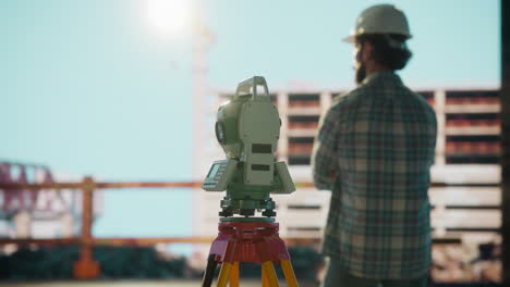 engineer and surveying equipment at construction site
