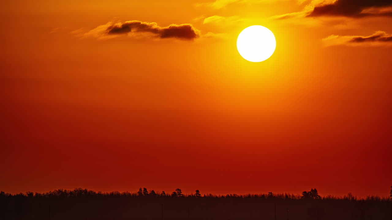 Timelapse of sun solely rising up, beautiful golden dawn in Latvia countryside