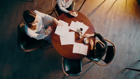 professionals collaborating at a table with documents and coffee