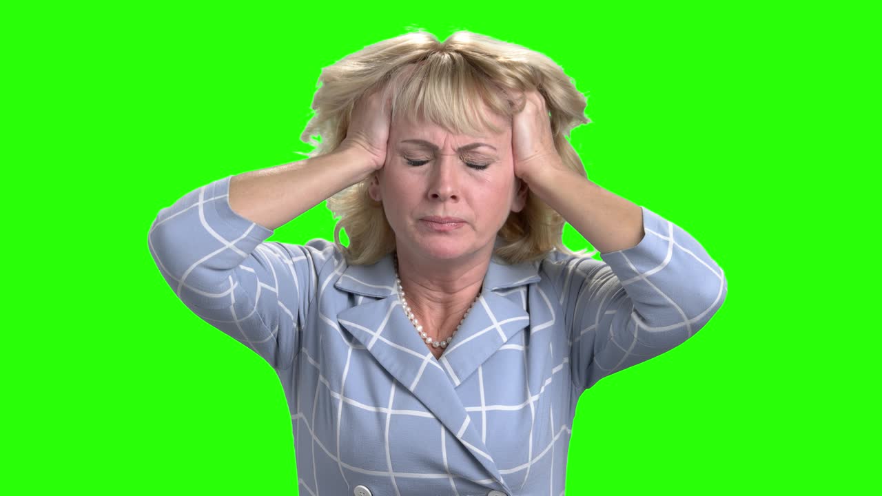 Desperate mature woman on green screen.