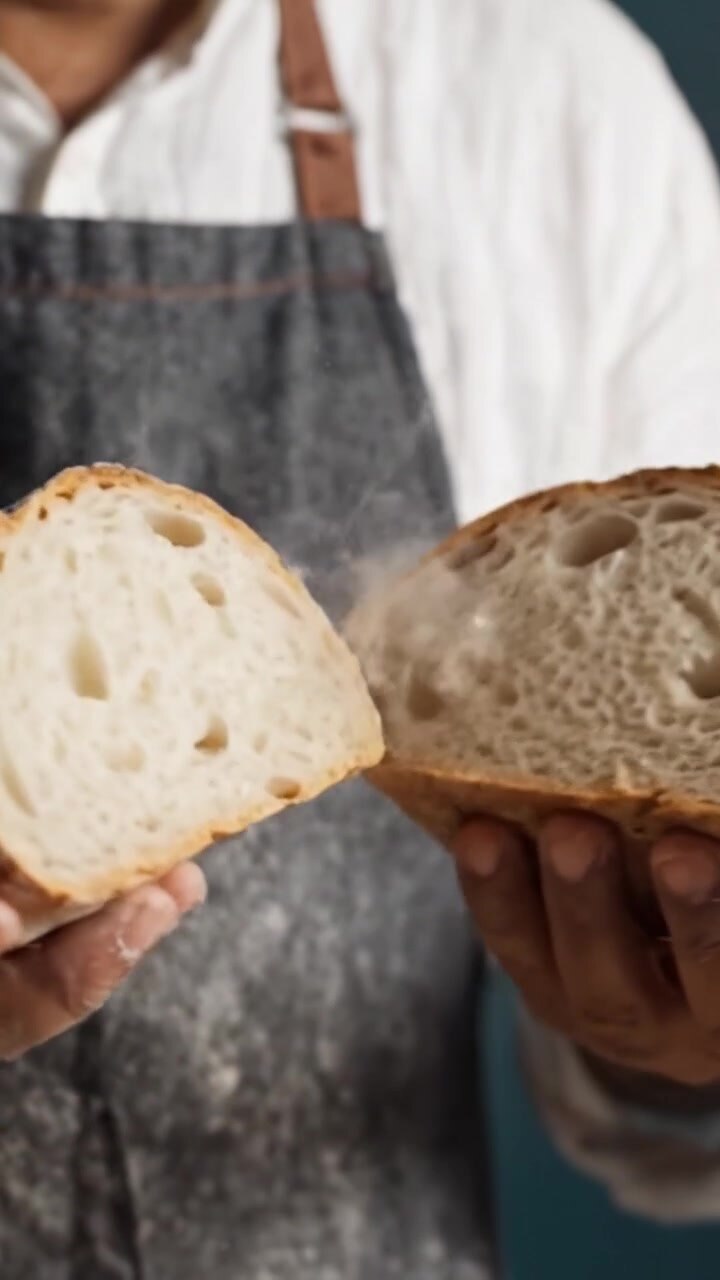 Artisan Baker Holding a Rustic Bread Loaf in Hands, Showcasing the Craftsmanship and Care in Baking, Beautifully Textured Crust and Warm Interior