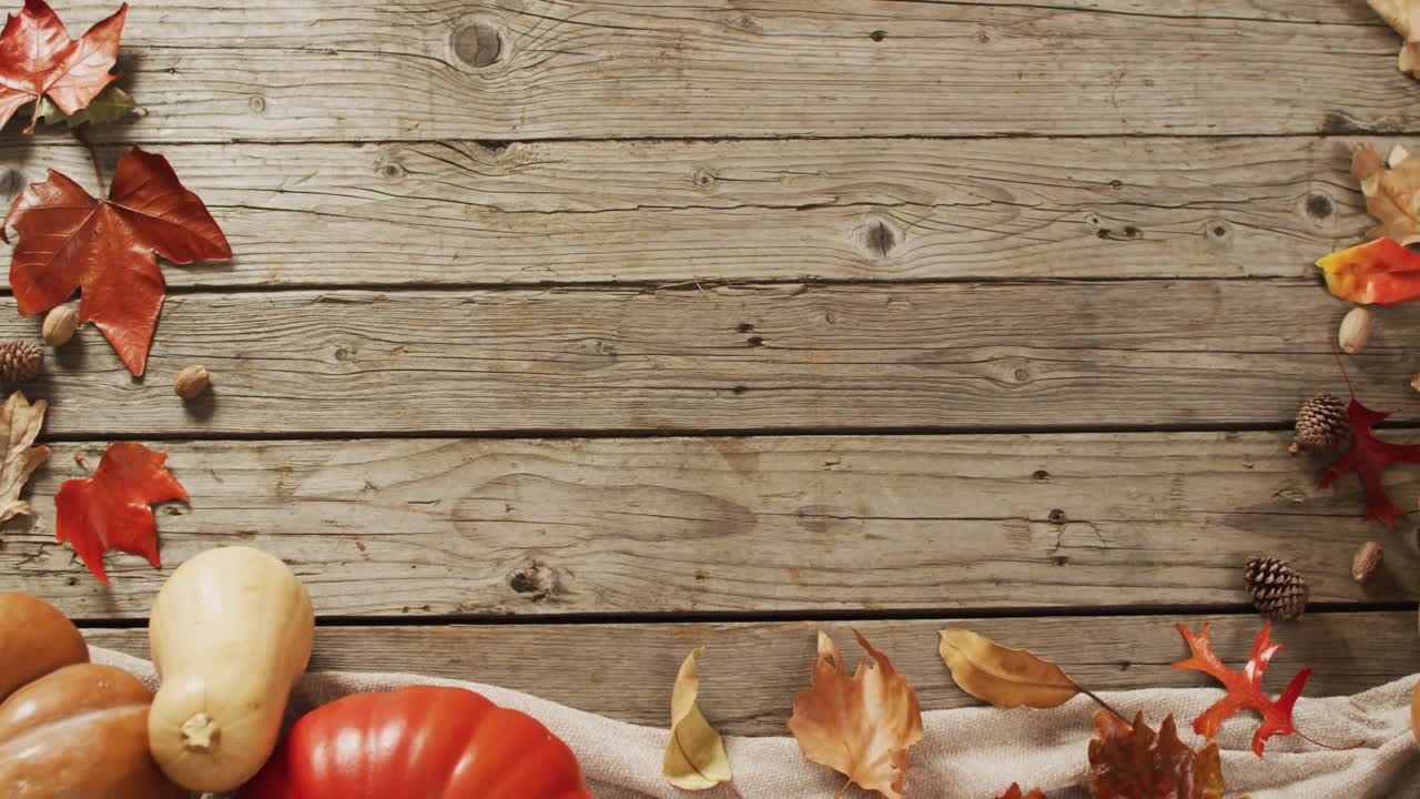 video de calabazas con piñas y hojas de otoño sobre fondo de madera