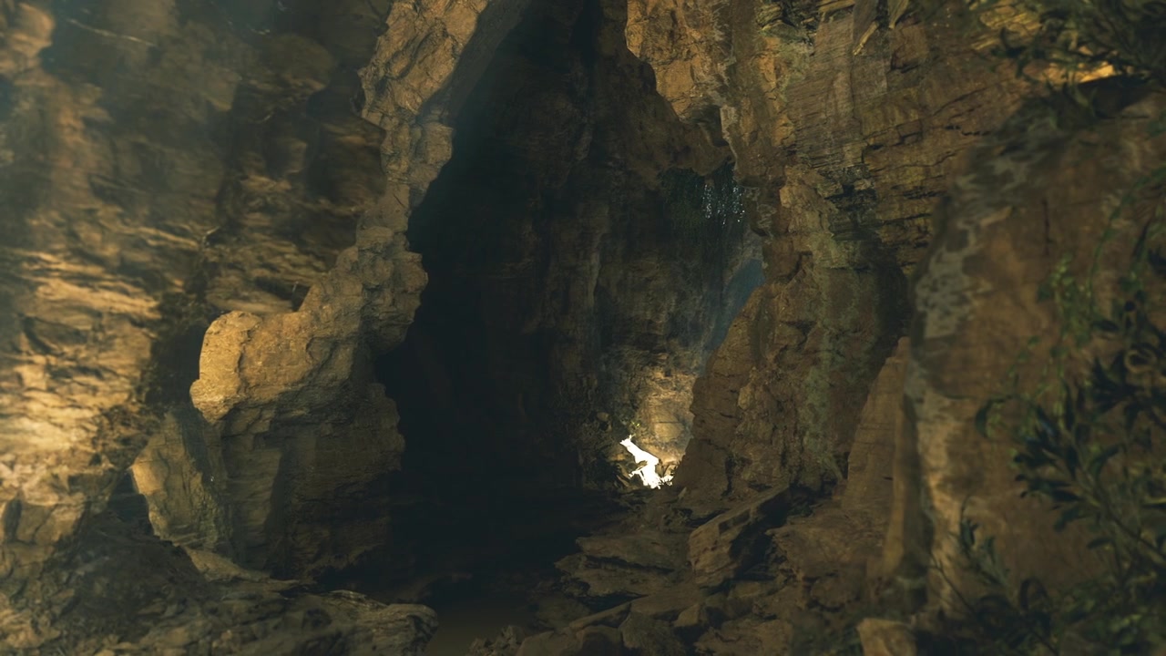 Bright opening in cavern highlights dark textures and serene silence