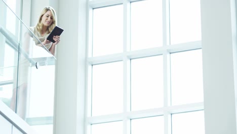 female caucasian business advisor using tablet in atrium