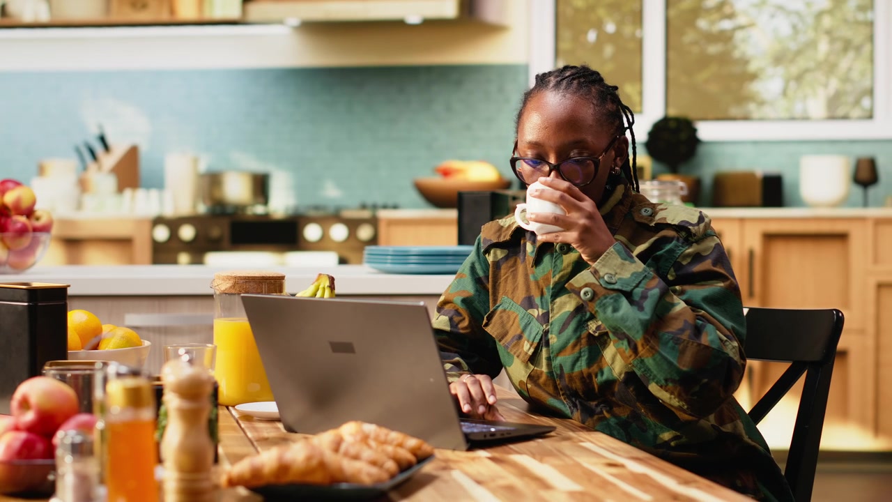Military woman in camouflage clothing enjoying peaceful morning with coffee