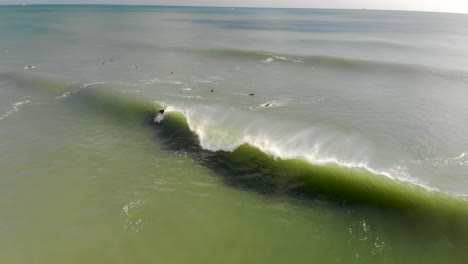 Epic-drone-tracking-shot-of-surfer-riding-a-wave