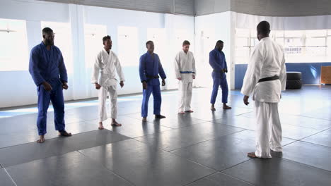 practicing judo, group of men in martial arts uniforms in training session