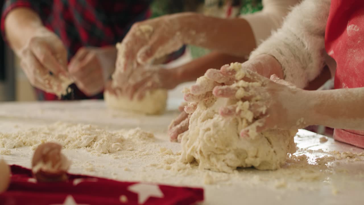 Tilt down view of family making cookies together for Christmas
