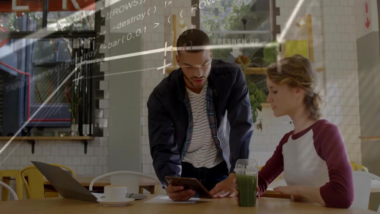 Man entering café and opening tablet initiating tech data overlays for review while woman listening