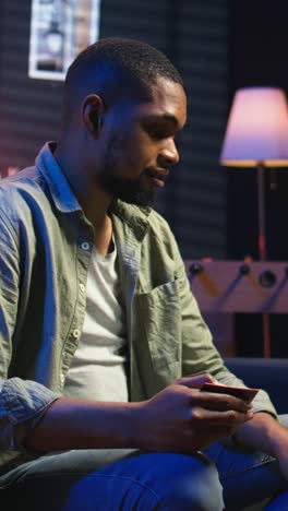vertical video young guy managing online banking and payments with the credit card