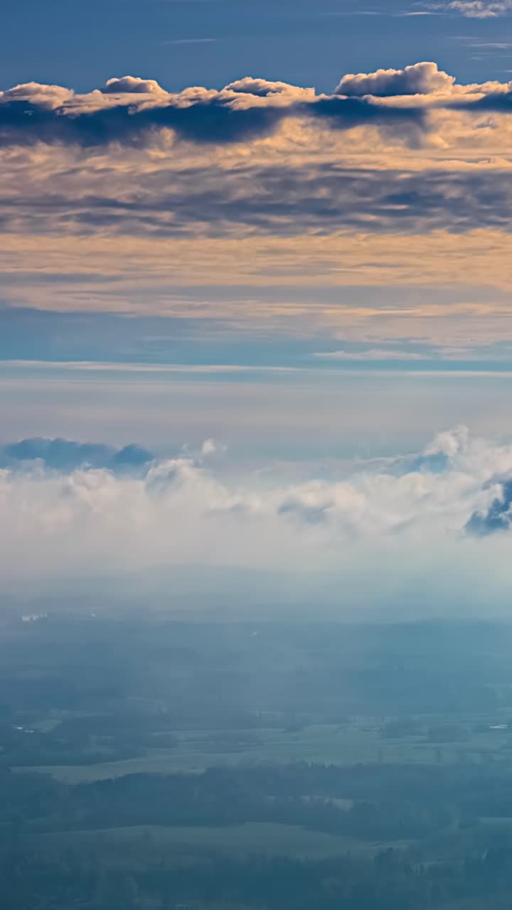 Soft Clouds Drift Over the Landscape as the Warm Hues of Dawn Paint the Sky Above - Vertical Timelapse Shot