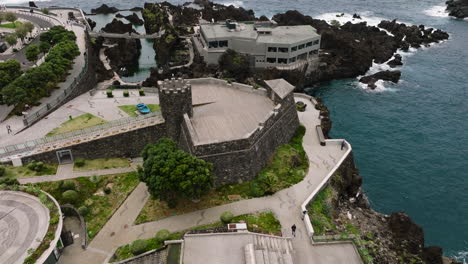 aerial orbit around madeira aquarium and view of ilheu mole