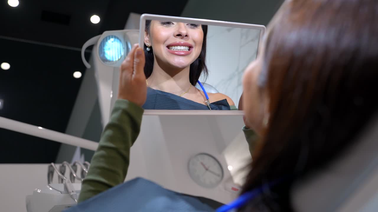 Woman at the dentist looking in a mirror