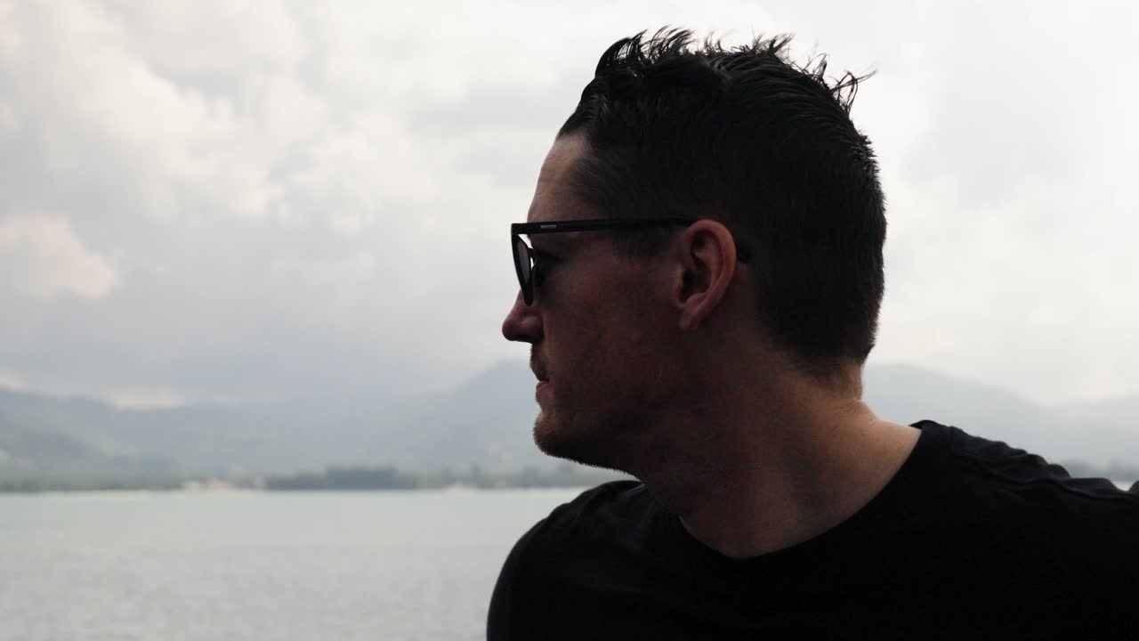 slow motion shot of a tourist standing on a ferry heading to Koi Samui in Thailand